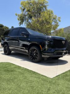 Black Cadillac Escalade with a professional ceramic coating in a San Diego driveway